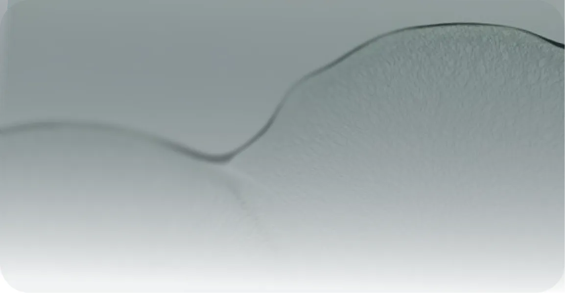 Close-up of a translucent, wavy textured surface with soft gray tones.