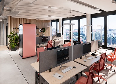 Modern office with desks, computers, red chairs, and large windows overlooking the city.