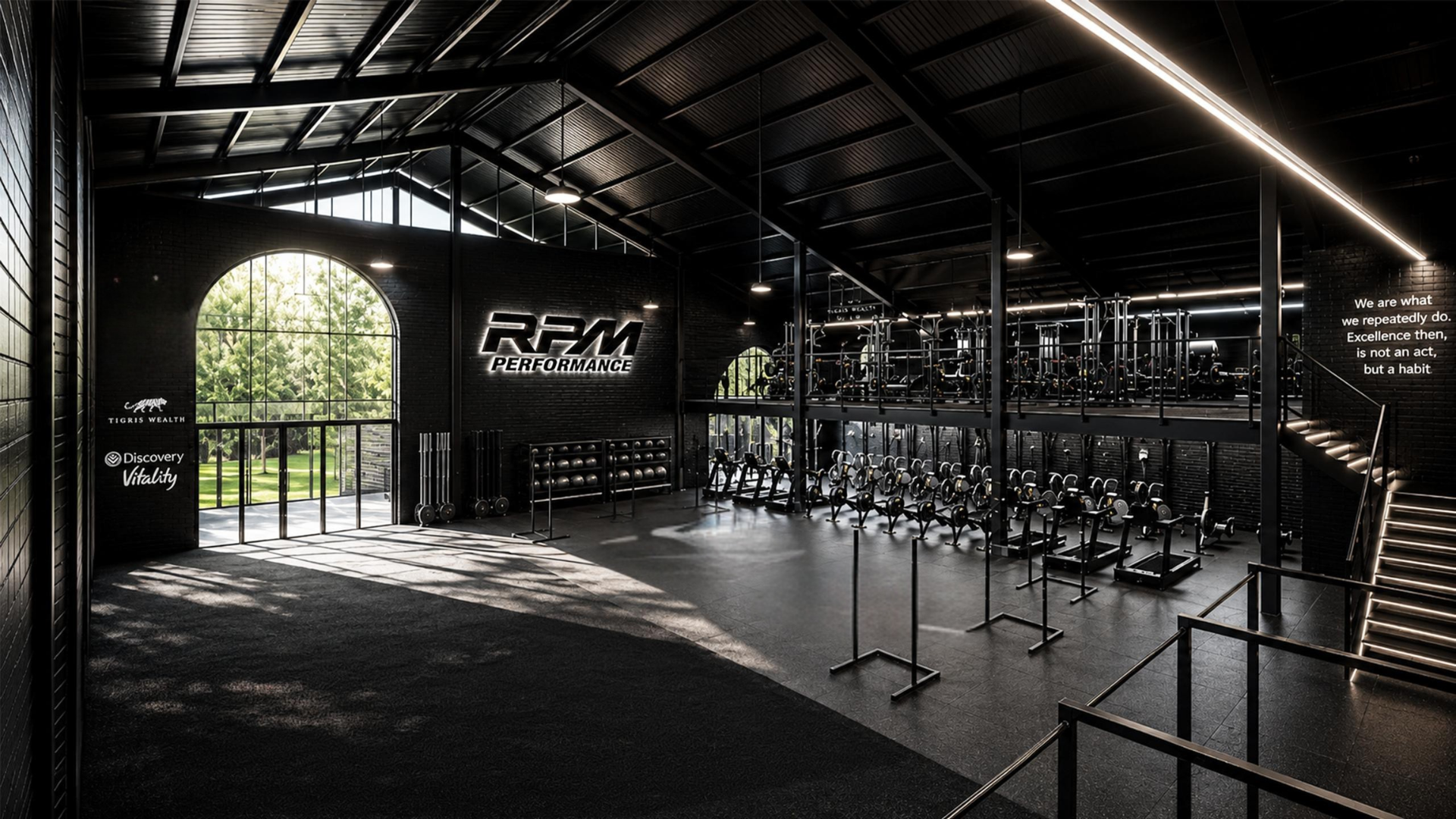Modern gym interior with weight racks, exercise bikes, large windows, and logos of Red Bull and Nike.