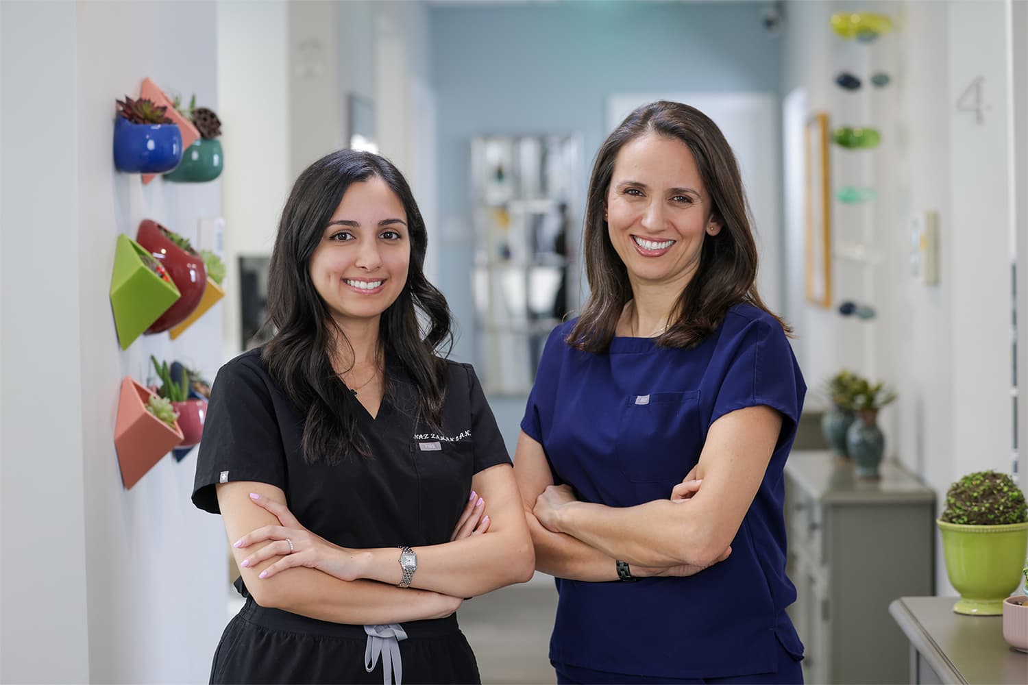 Two dentists in West Portal, San Francisco posing inside of their practice