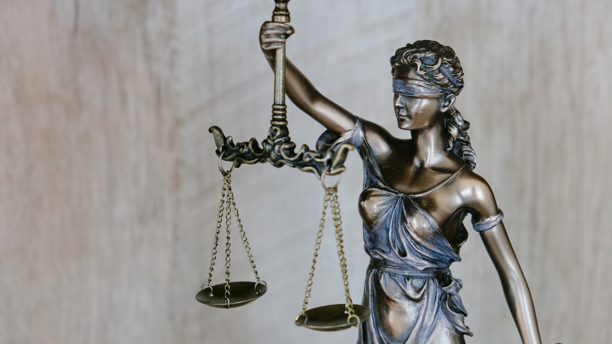 Lady Justice with scales, representing the AI claim-denial court ruling