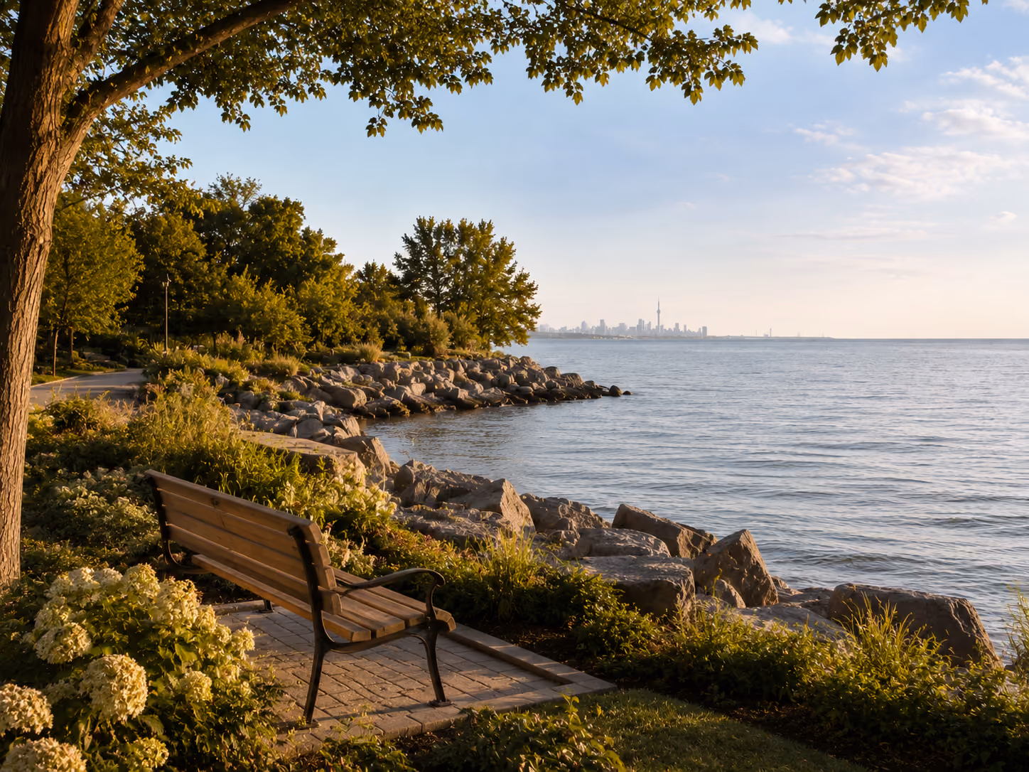 Lake Ontario waterfront park bench with Toronto skyline