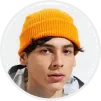 Portrait of a young man with light skin wearing an orange knit beanie and a gray shirt, looking slightly to the side.