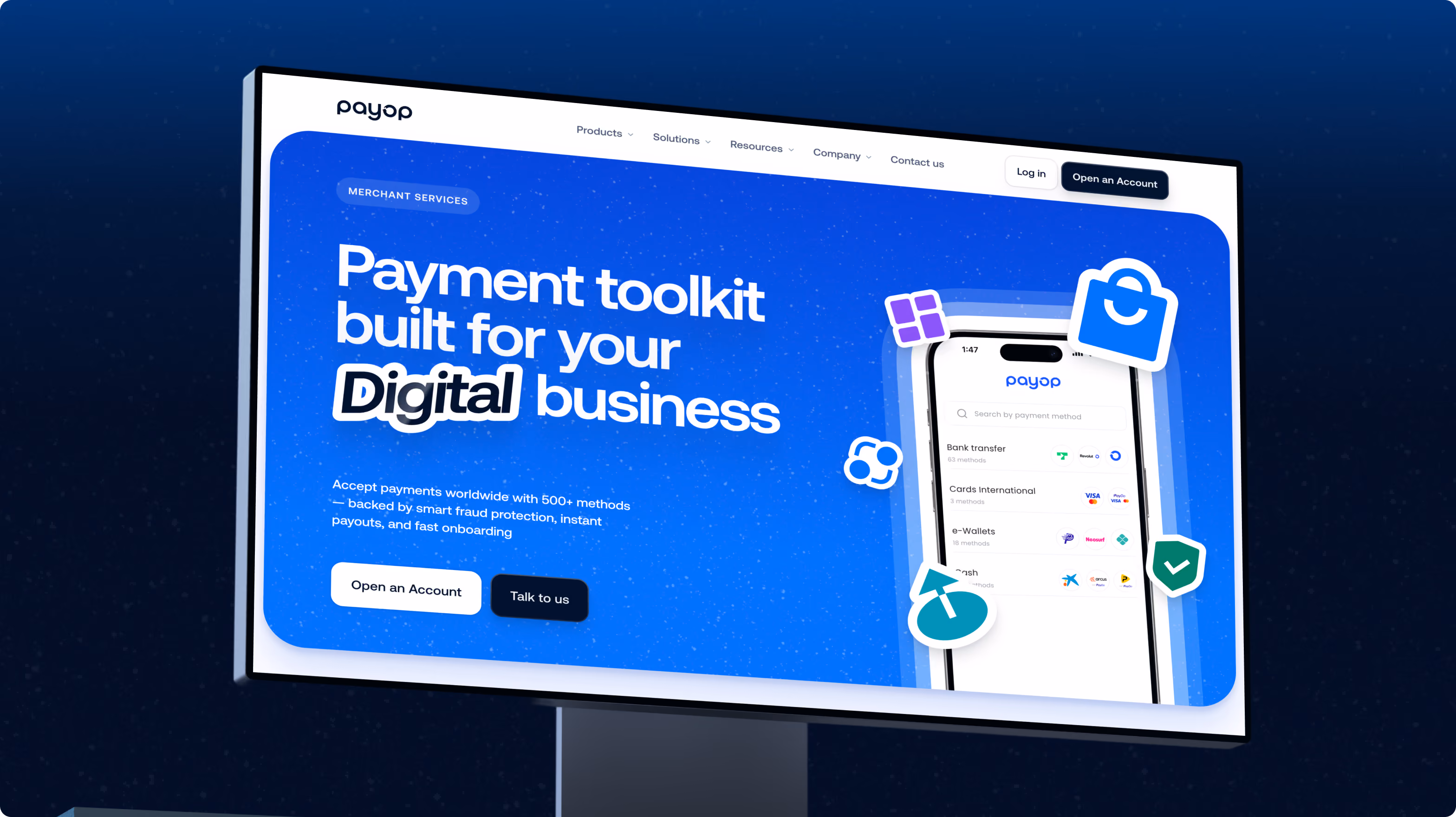 Billboard at night advertising Payop, featuring a blue and white digital payment toolkit for businesses with buttons labeled 'Open an Account' and 'Talk to us' and a partial image of a smartphone screen showing payment method options.