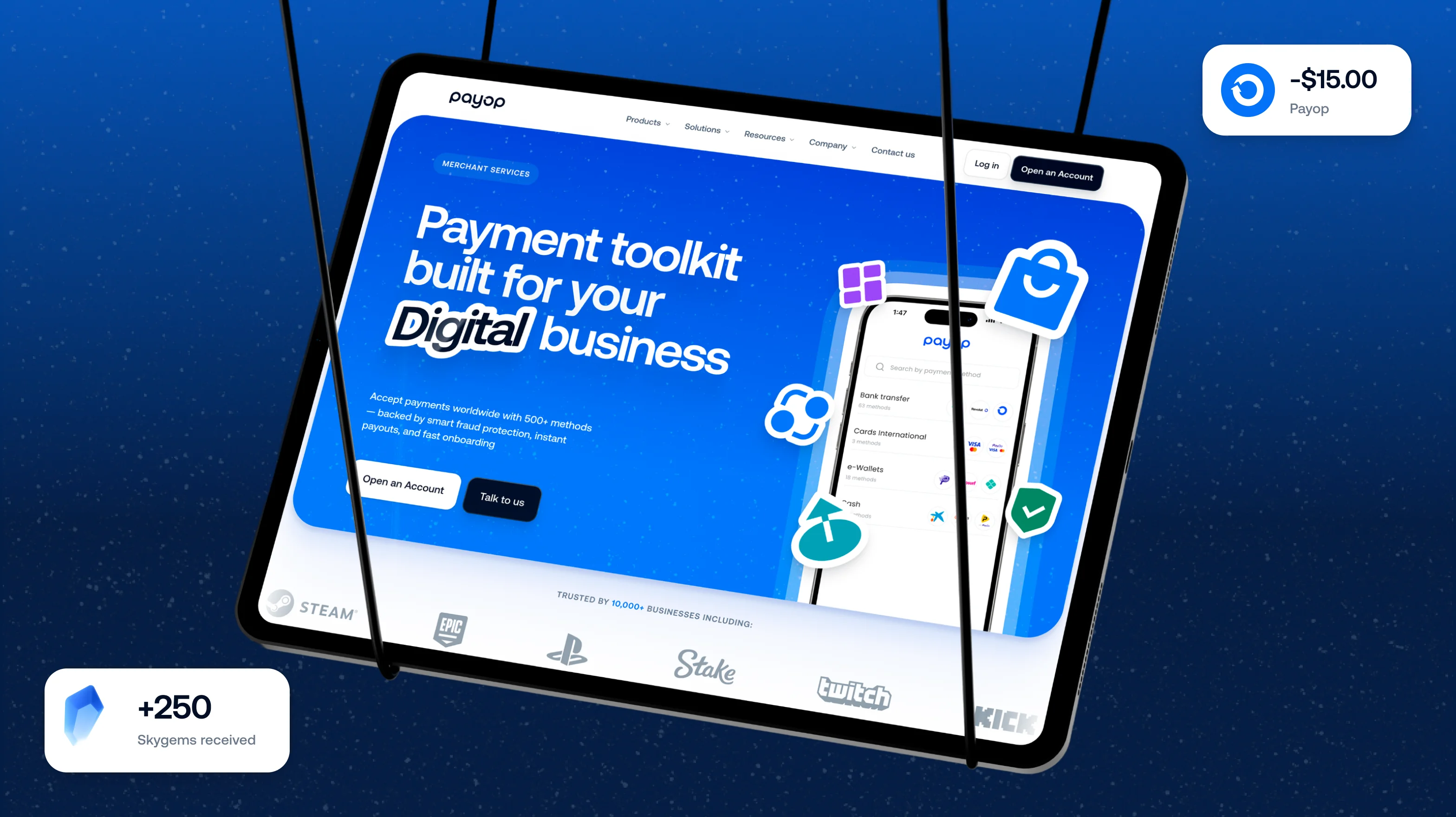 Tablet showing Payop website page with headline 'Payment toolkit built for your Digital business' and options to open an account or talk to us, surrounded by digital service icons and logos of trusted businesses including Steam, Epic, PlayStation, Stake, Twitch, and Kick, all on a blue starry background.