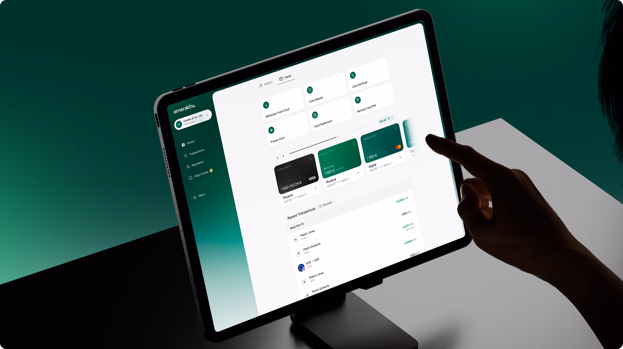Person interacting with a tablet showing a financial dashboard featuring card options, balances, and recent transactions on a gradient green and white interface.