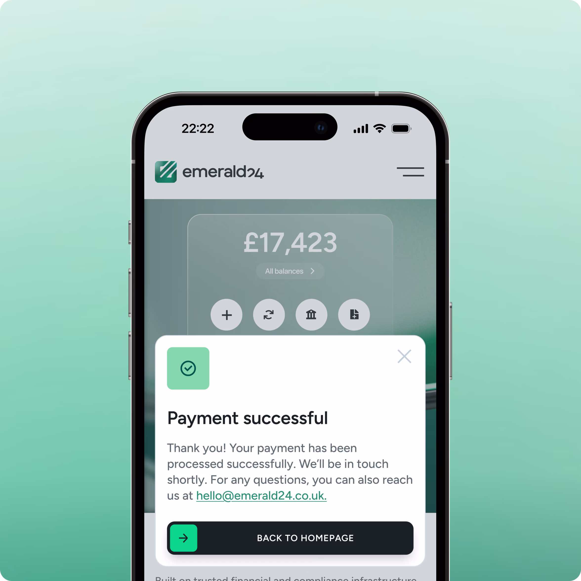 Smartphone screen displaying Emerald24 app with a balance of £17,423 and a pop-up message confirming successful payment, thanking the user and providing contact email hello@emerald24.co.uk, with a 'Back to Homepage' button.