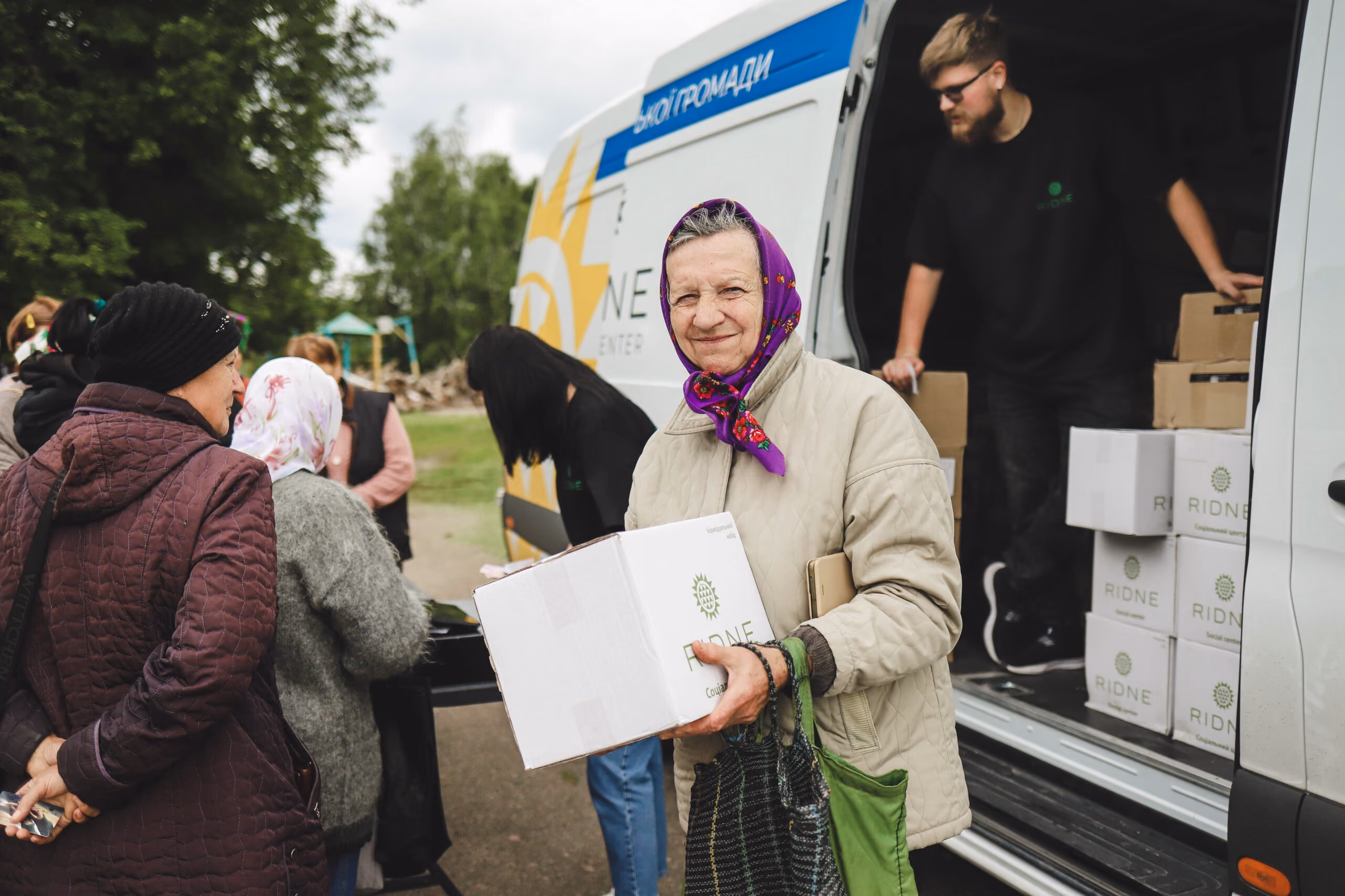 Woman receiving a RIDNE food box during mobile outreach