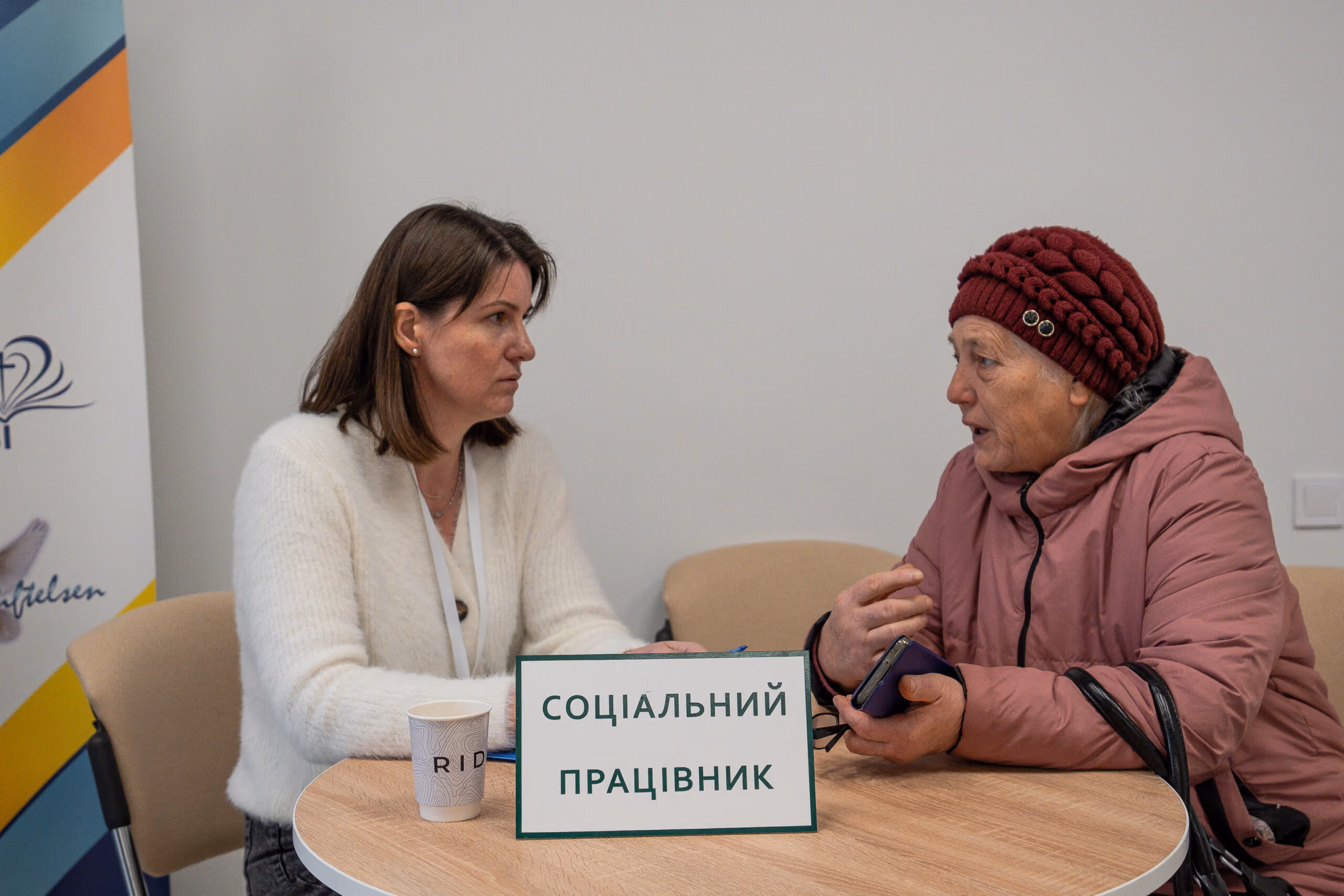 Social worker speaking with an older visitor