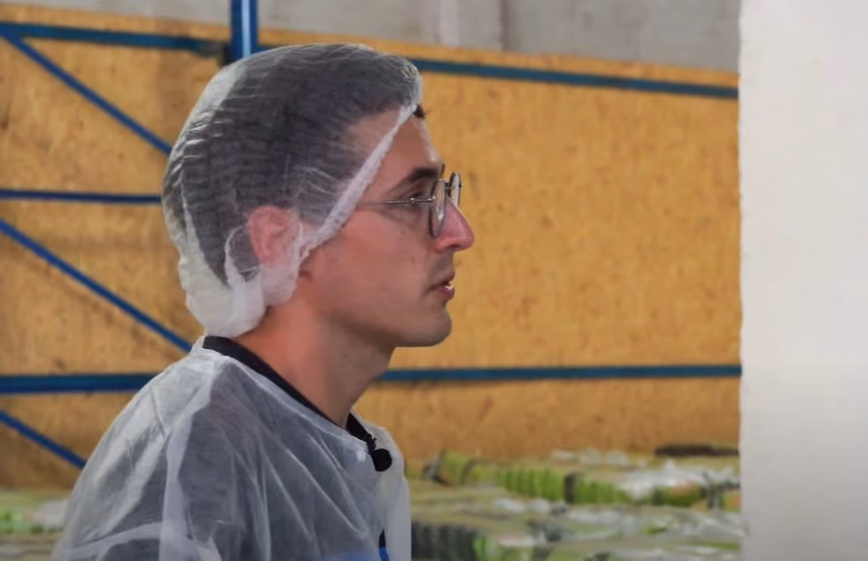 Worker operating food-packaging equipment at a Ukrainian factory
