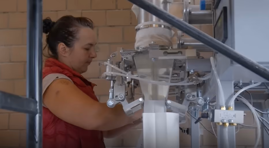 Worker operating a food-packaging line