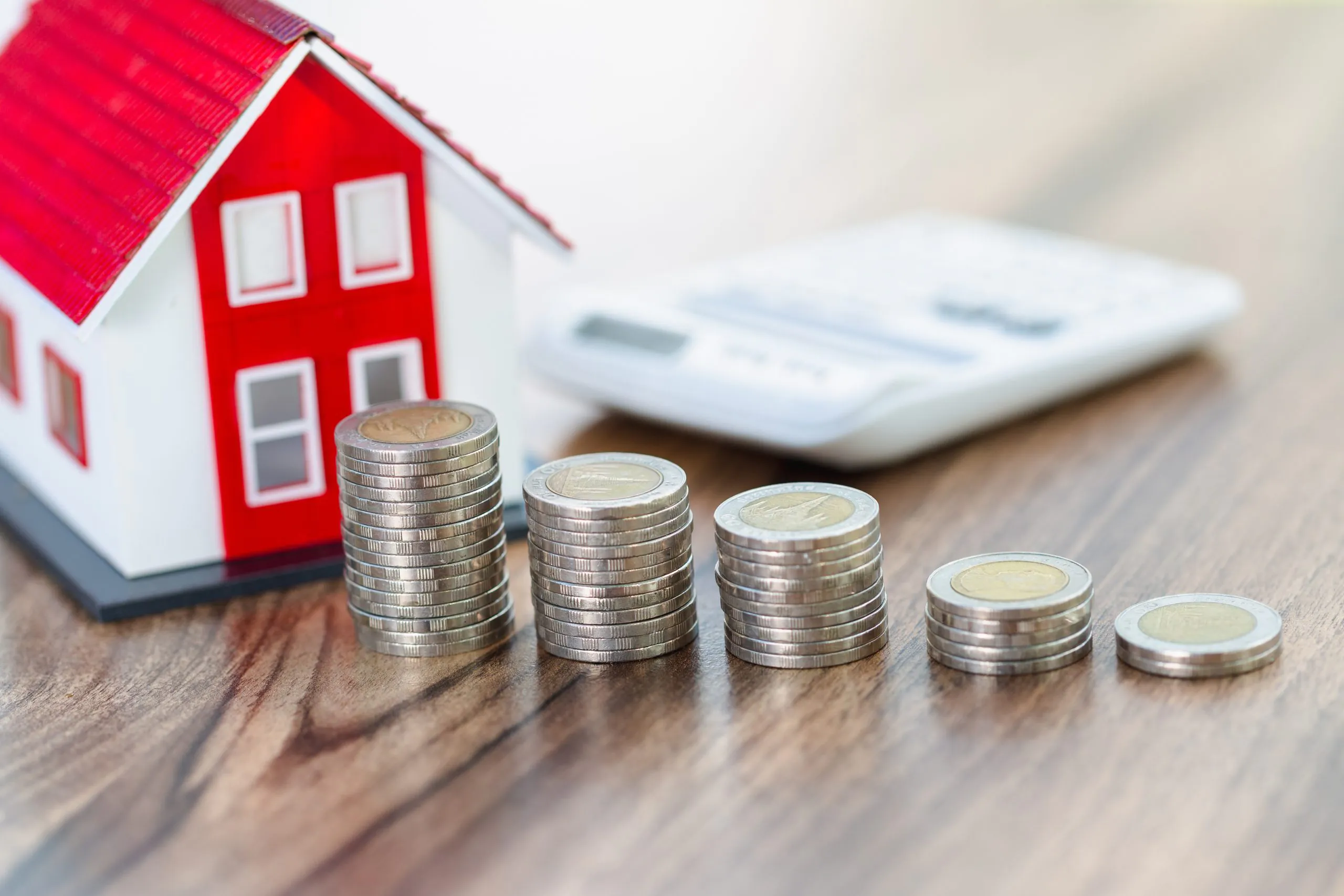 coin stack with house model, savings plans for housing ,financial concept,Concept of real estate investment.