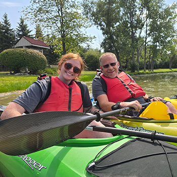 Nick, the NeuroCare Home Health founder out on the water with Izzy, one of our caregivers, both in a kayak