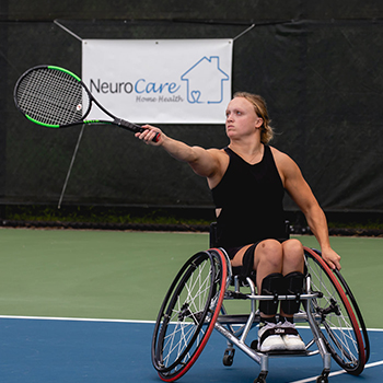 A person in a wheelchair playing tennis