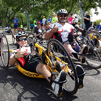 A group of hand cyclers gearing up for a ride