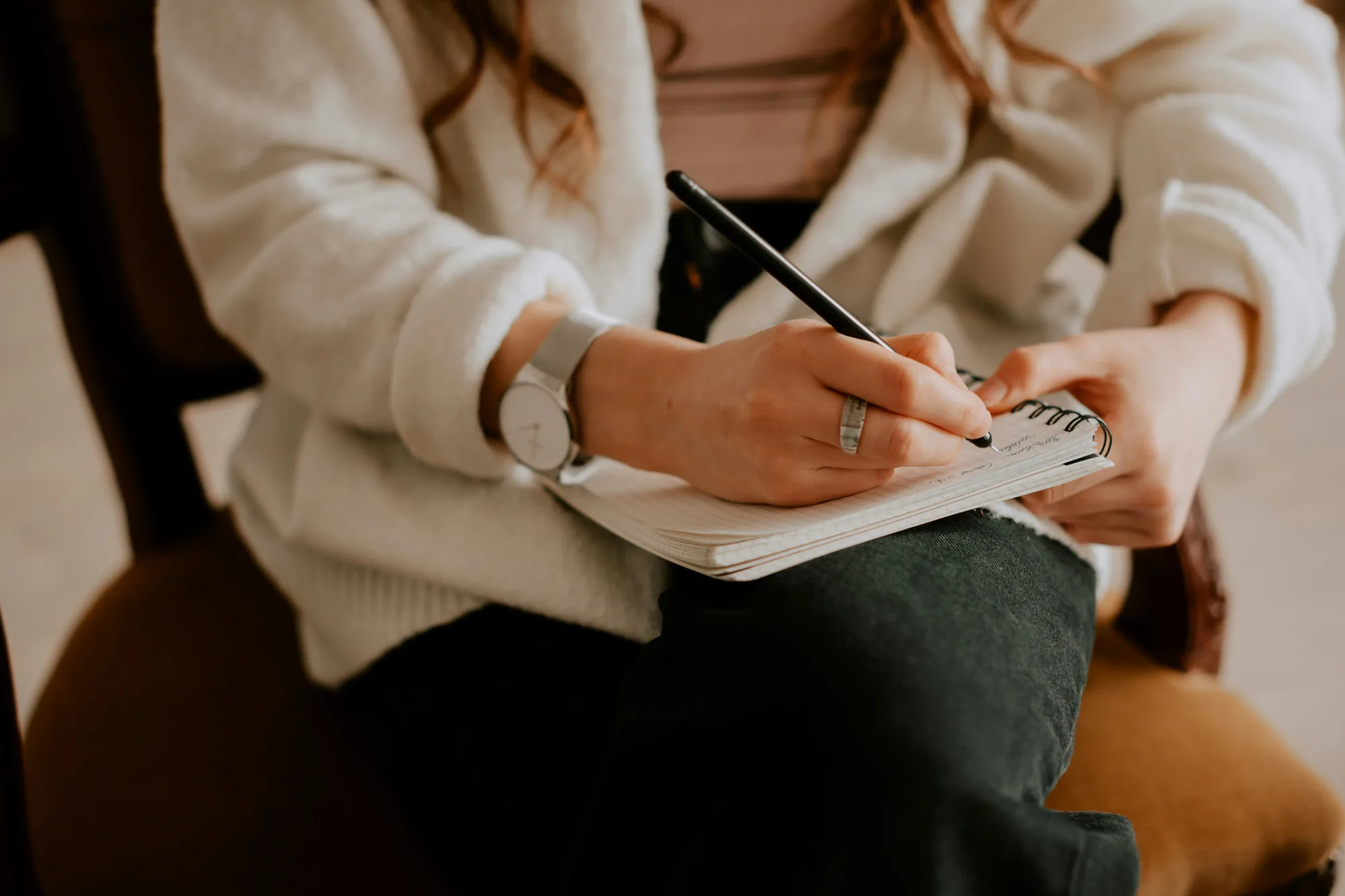 A person writing notes in a notebook