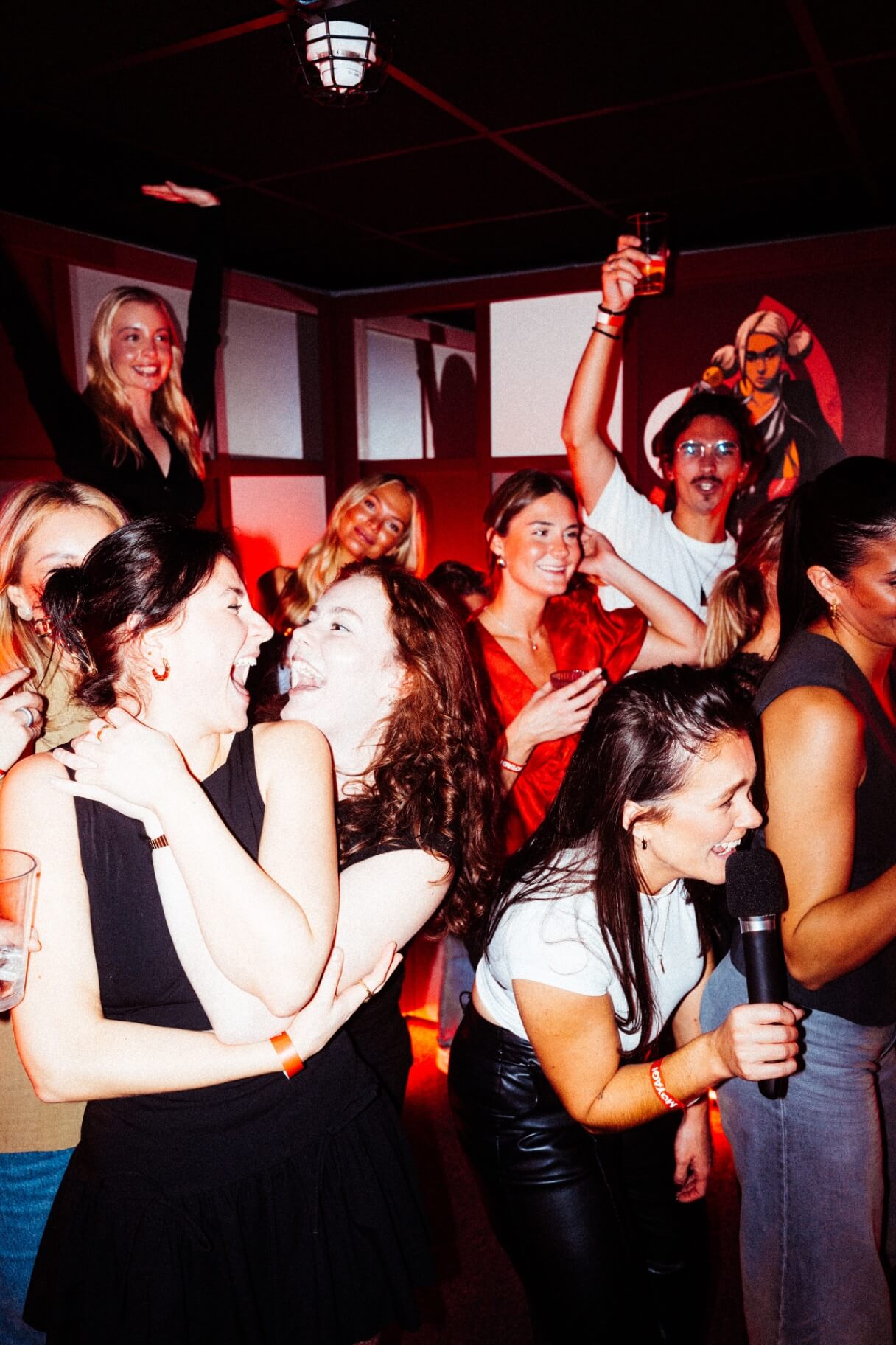 Friends laughing and singing karaoke at Moyagi London