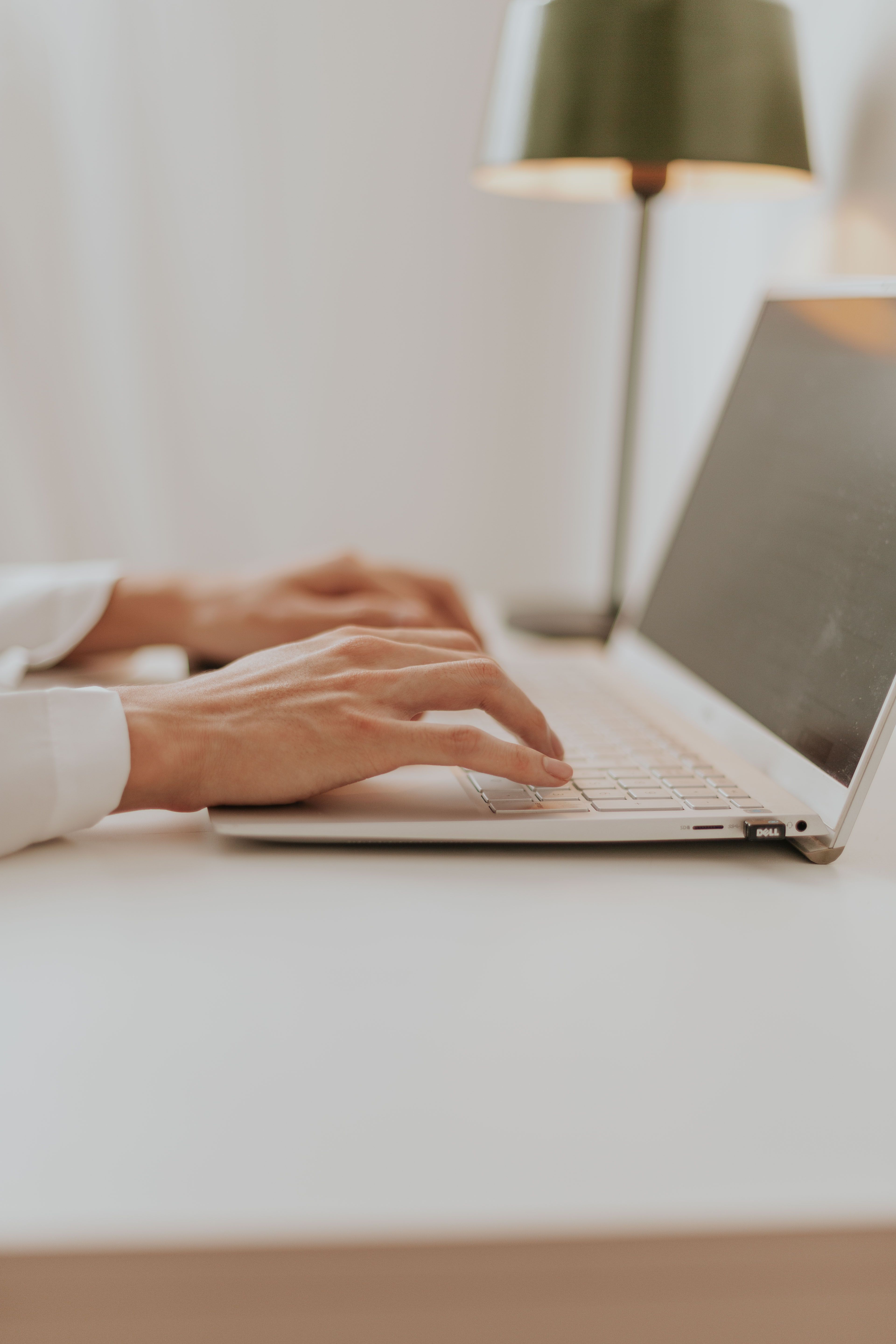 A person typing on a laptop