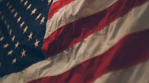 Close-up of a waving American flag showing stars and red and white stripes.