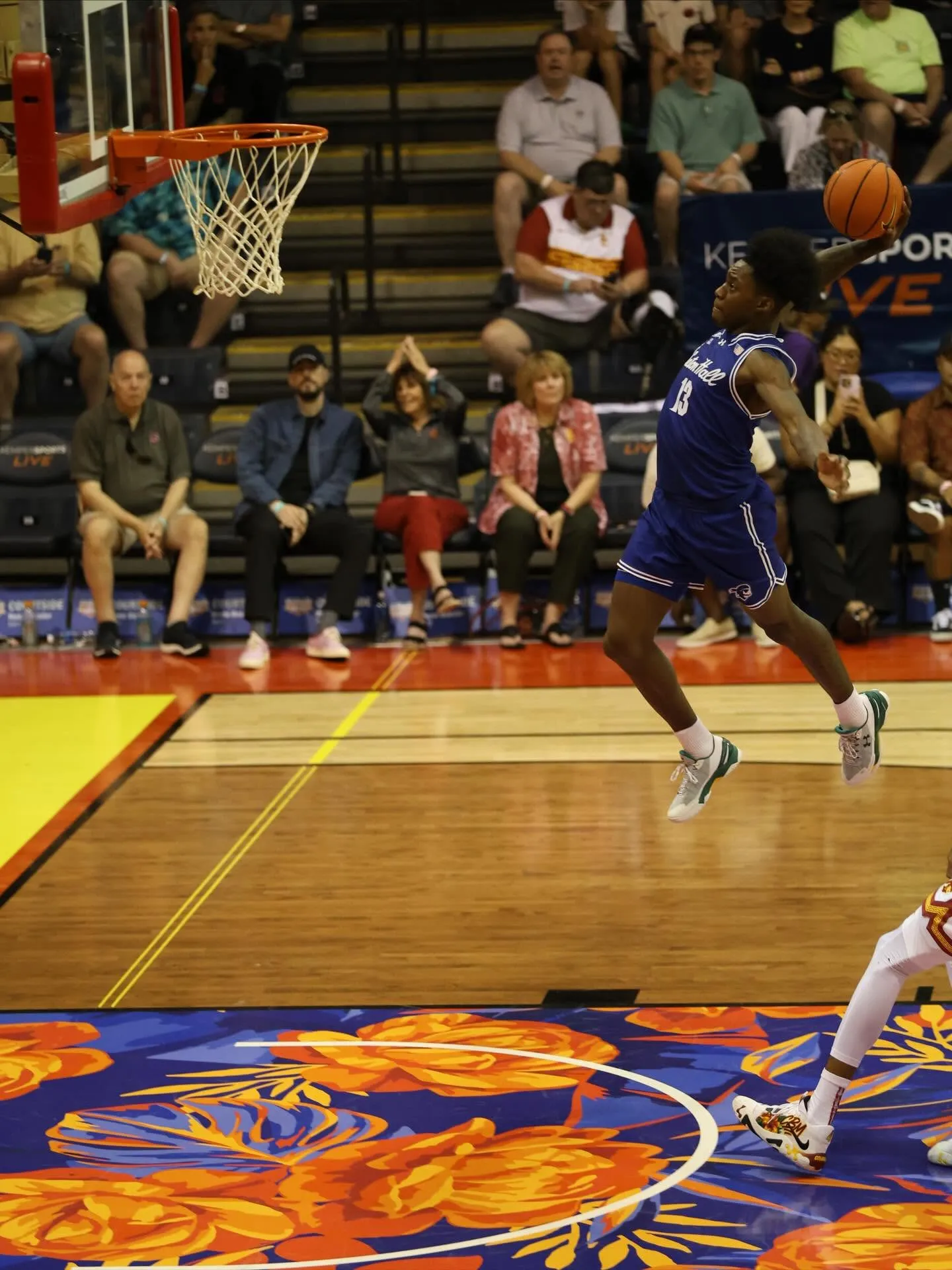 basketball player making a dunk at game