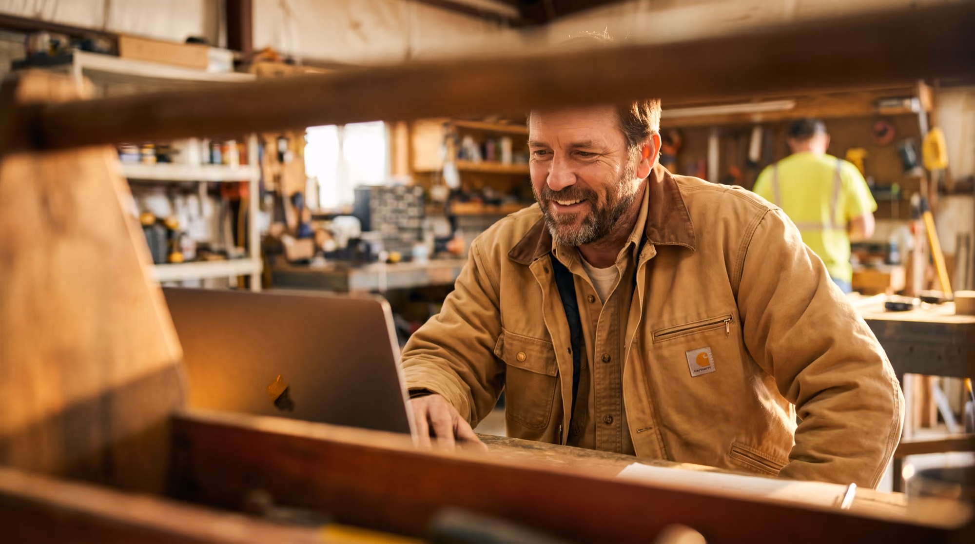 Worker joining a virtual supervisor-training session on a laptop in the shop
