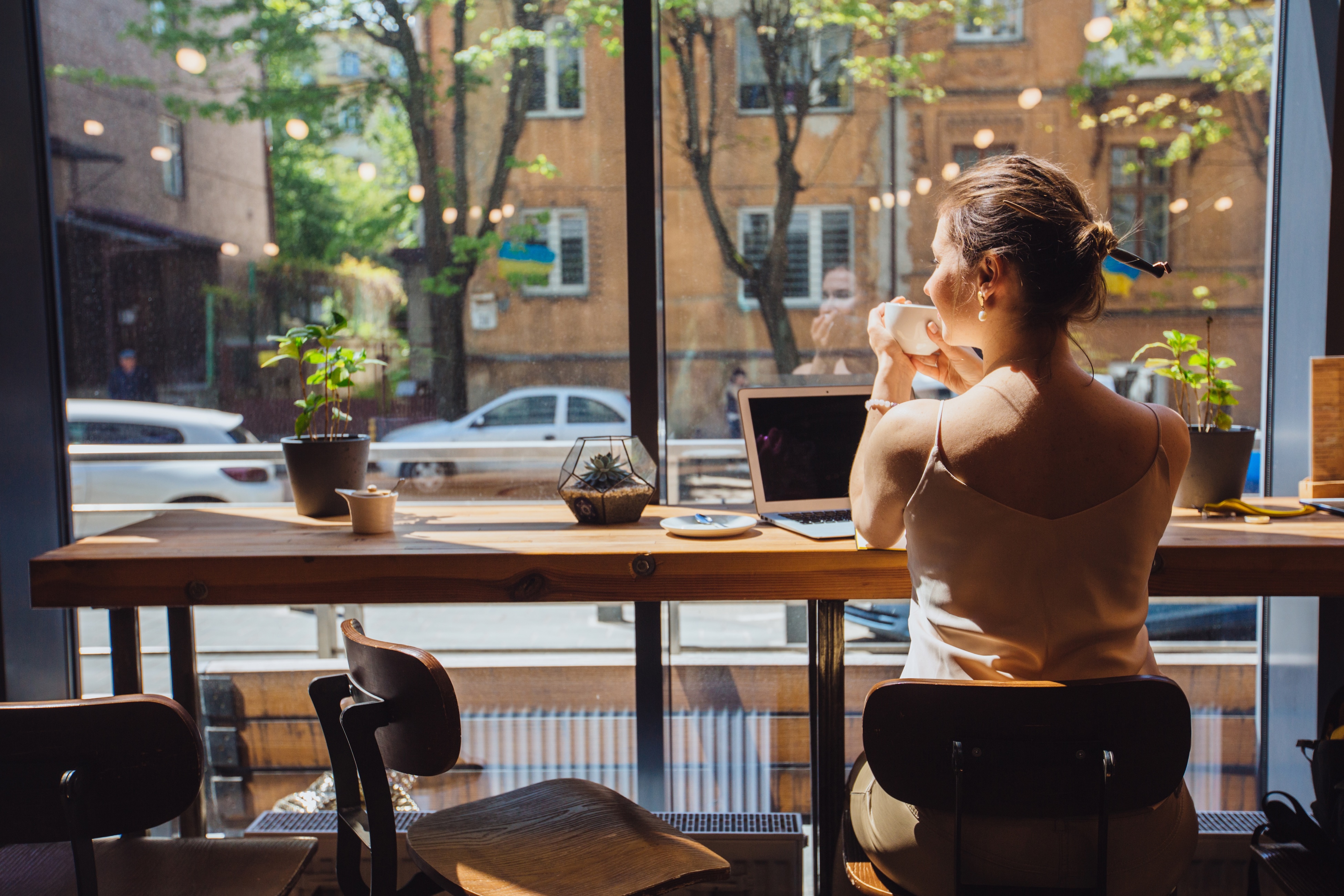 Woman sitting at a bar with a cup of coffee stock image