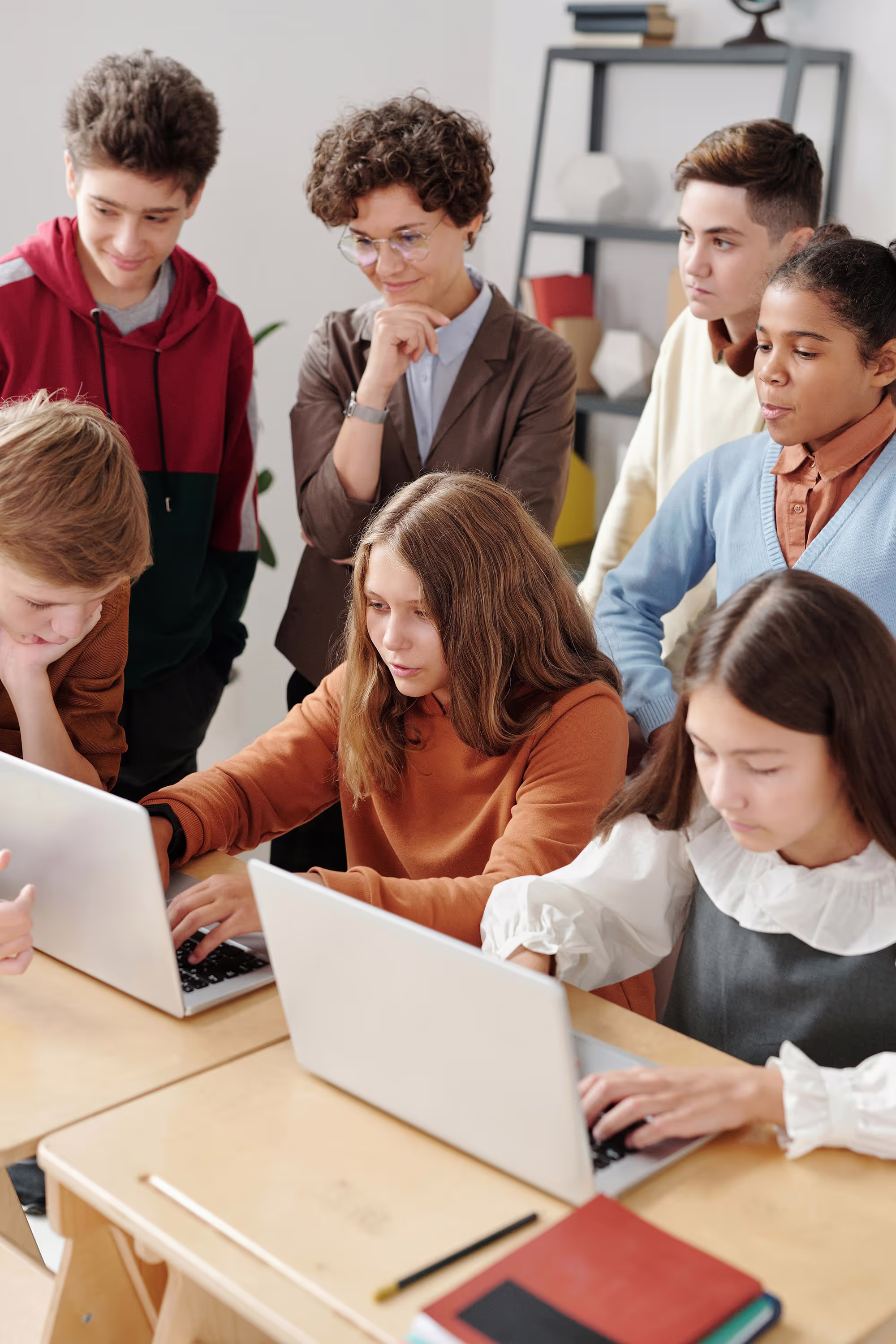 Students are seated in a classroom, focusing on their work