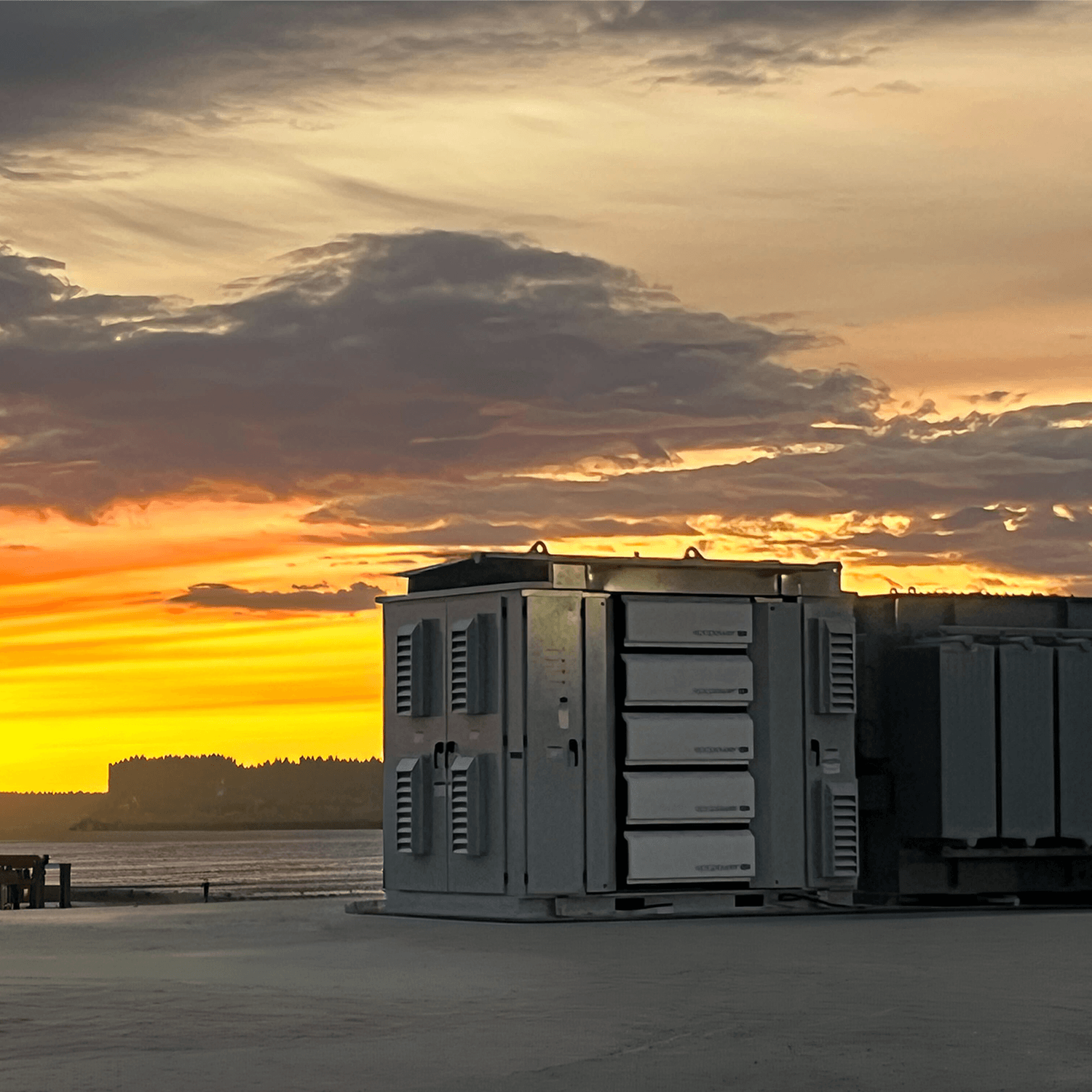 EPC Industrial equipment on a rooftop against a dramatic orange and gray sunset sky.