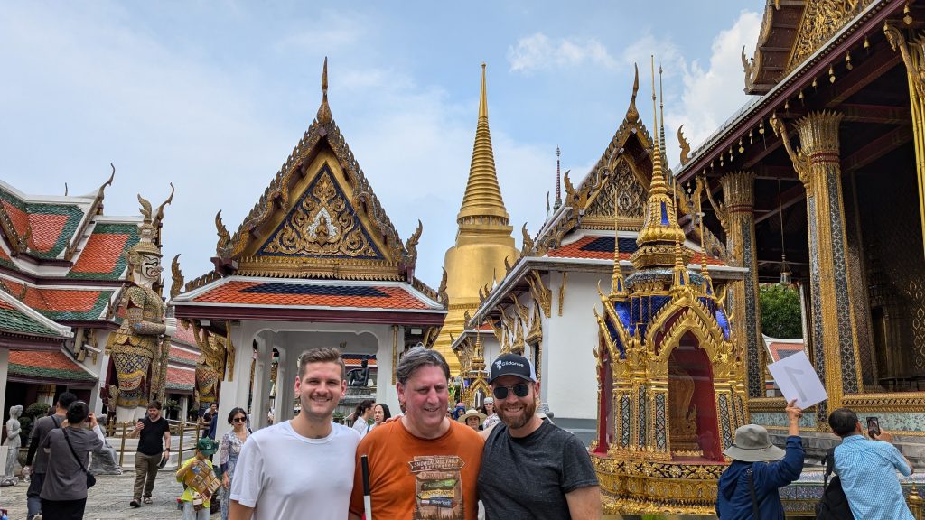 Co-founders Kyle, Luke, and Amos doing some sightseeing at a local temple in Thailand.