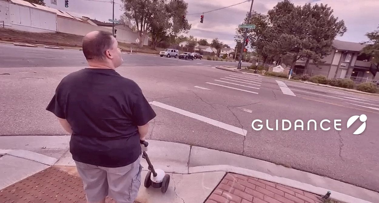 Casey Mathews preparing to cross a major street in his neighborhood with Glide.