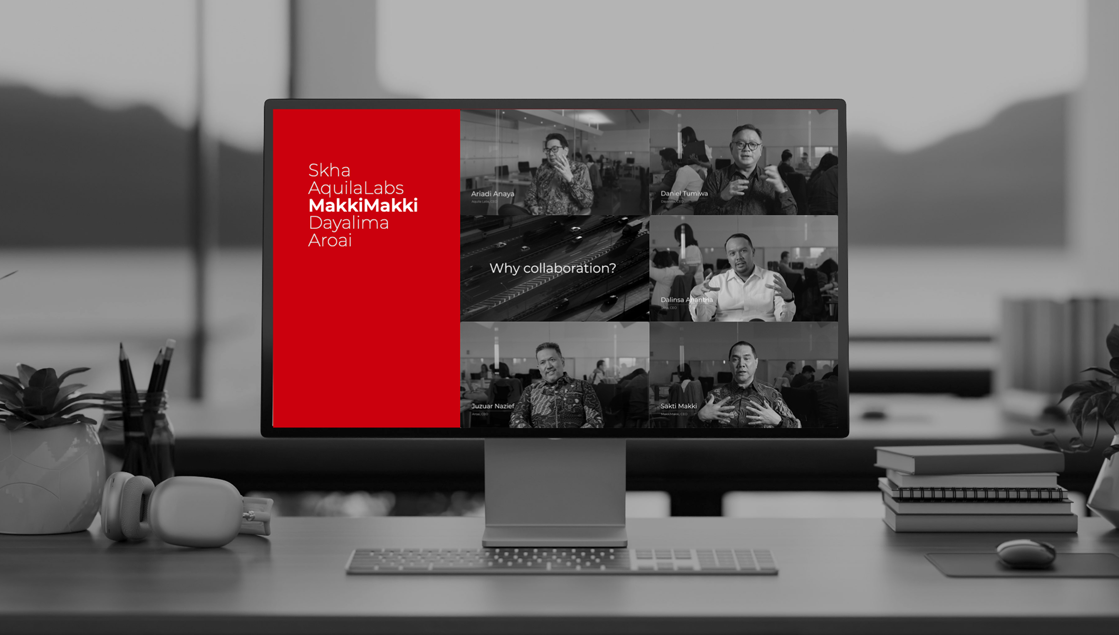 Computer screen on a desk displaying a video call with six participants, all men speaking and gesturing, next to a red sidebar listing names: Skha, AquilaLabs, MakkiMakki, Dayalima, Aroai, and the question 'Why collaboration?' in the video call center.
