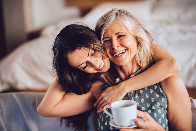 Image of a woman hugging an older woman.
