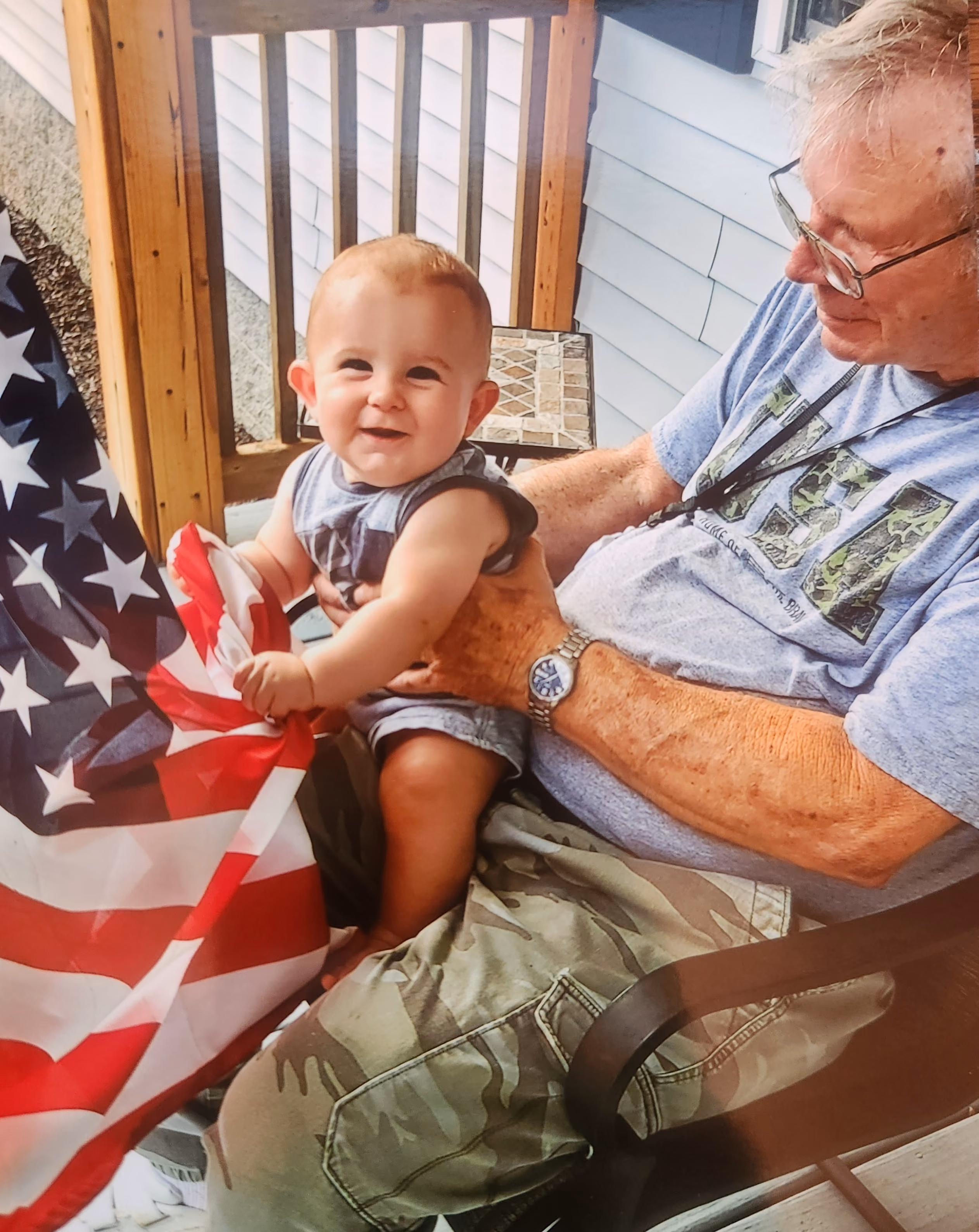 Image of a child sitting on a man's lap.
