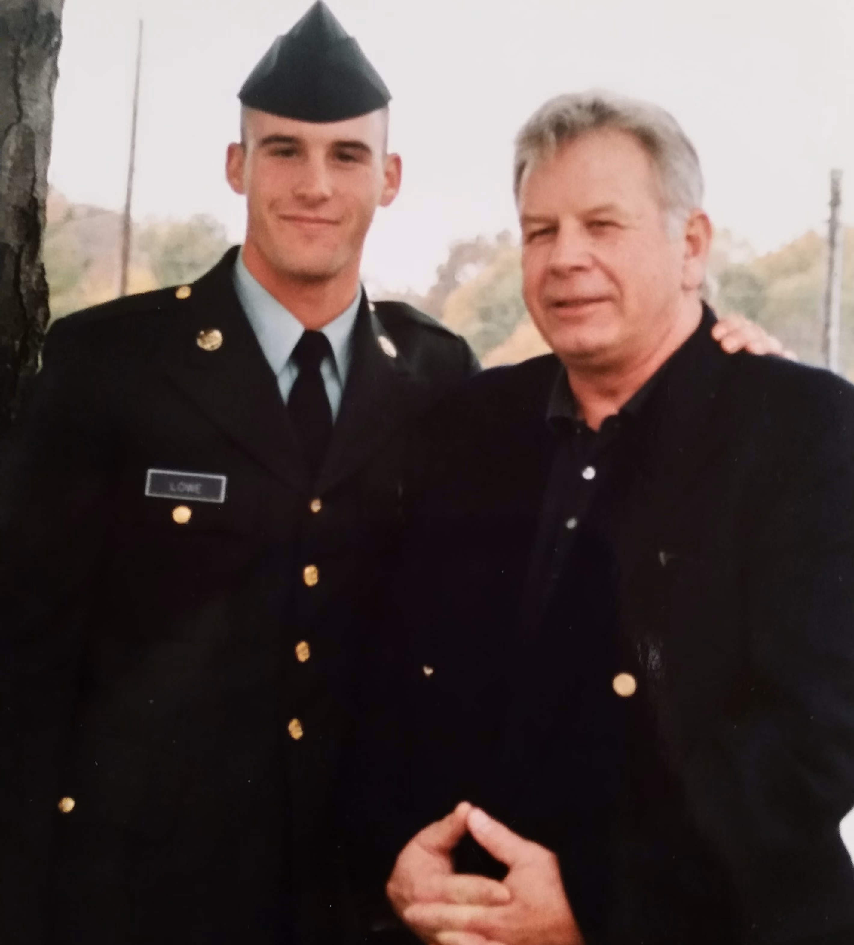 Image of Chris Lowe, in uniform, stnading with his father.