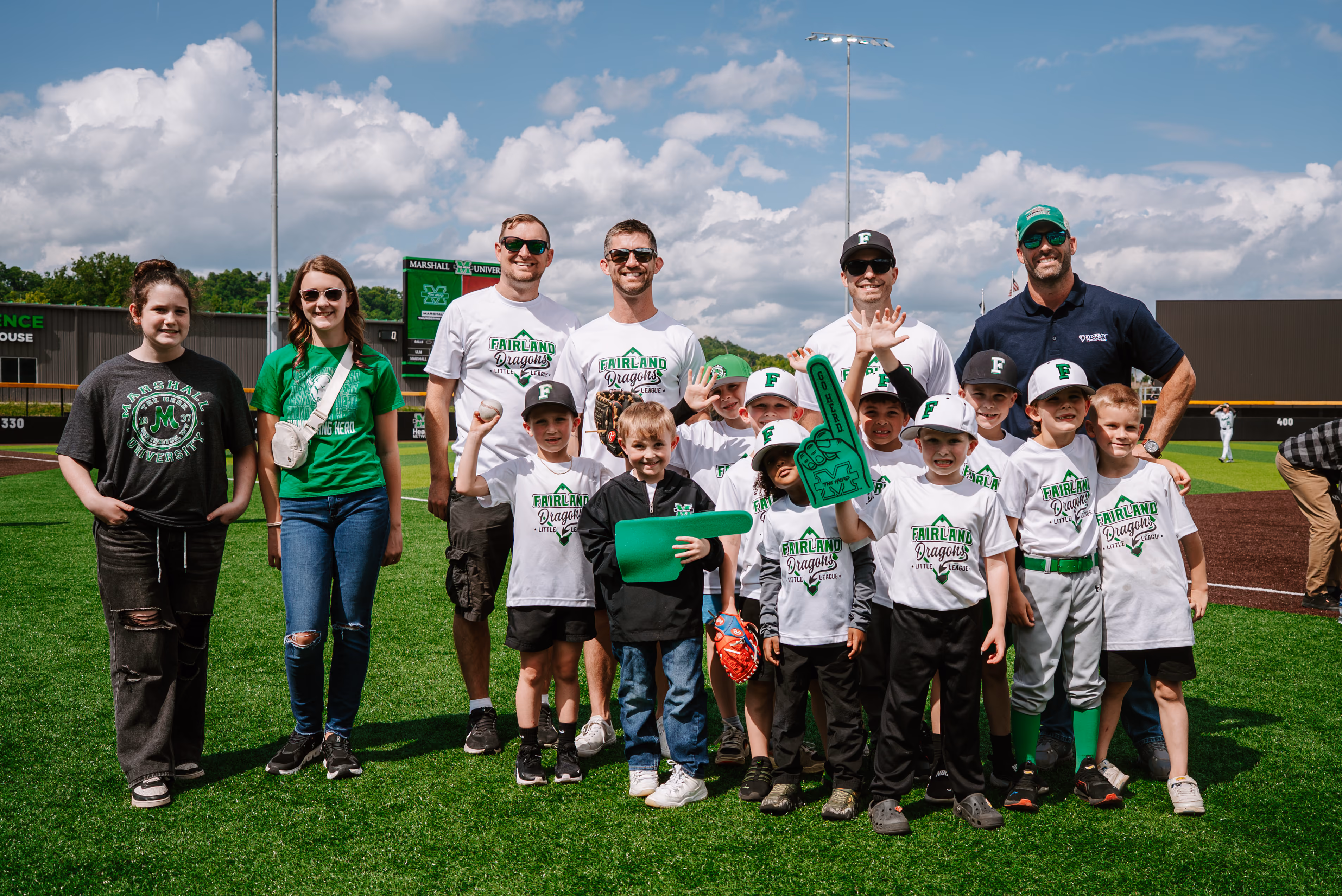 Image of a youth baseball team standing on a baseball field.