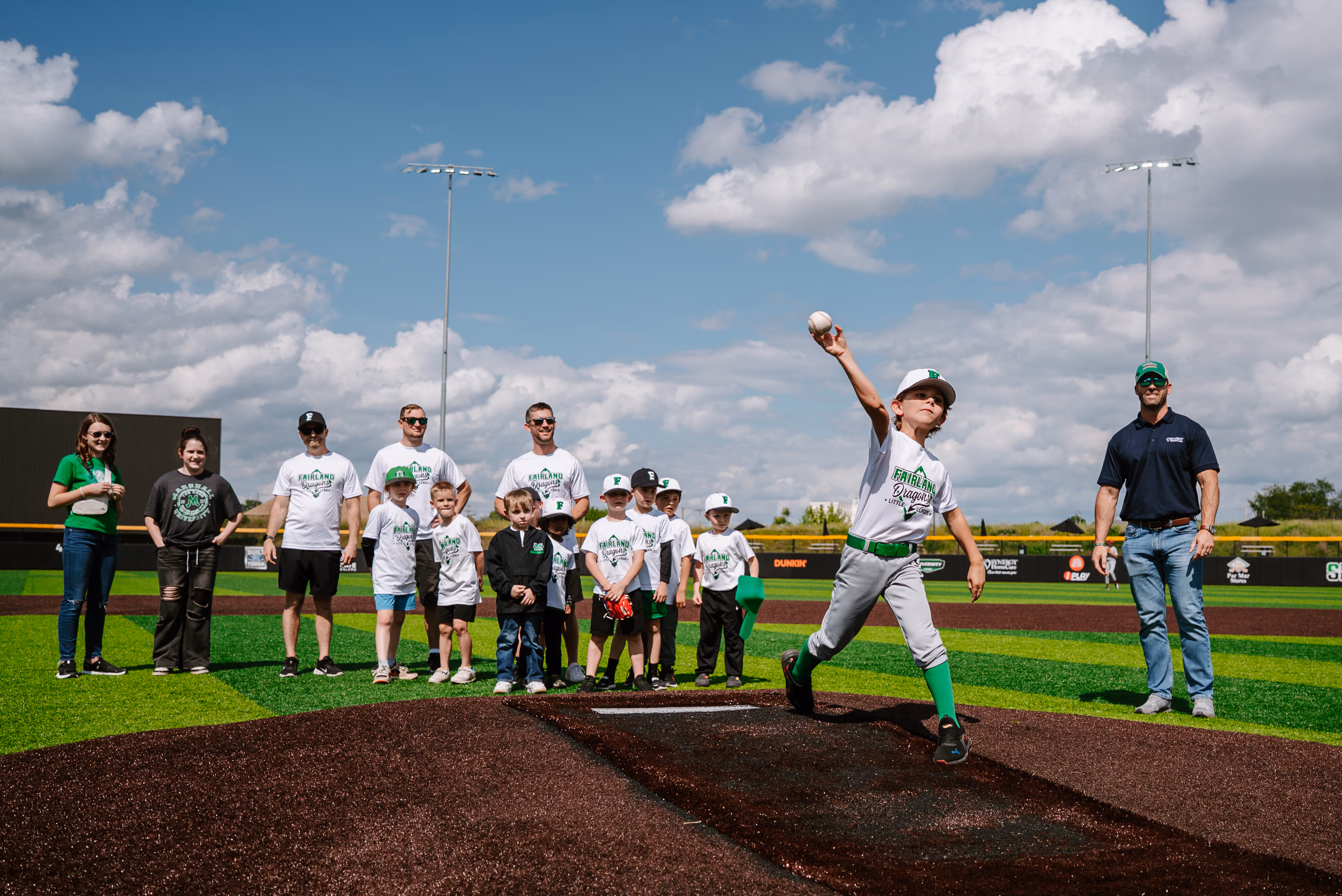 Image of a child throwing a baseball off of the pitcher's mound.
