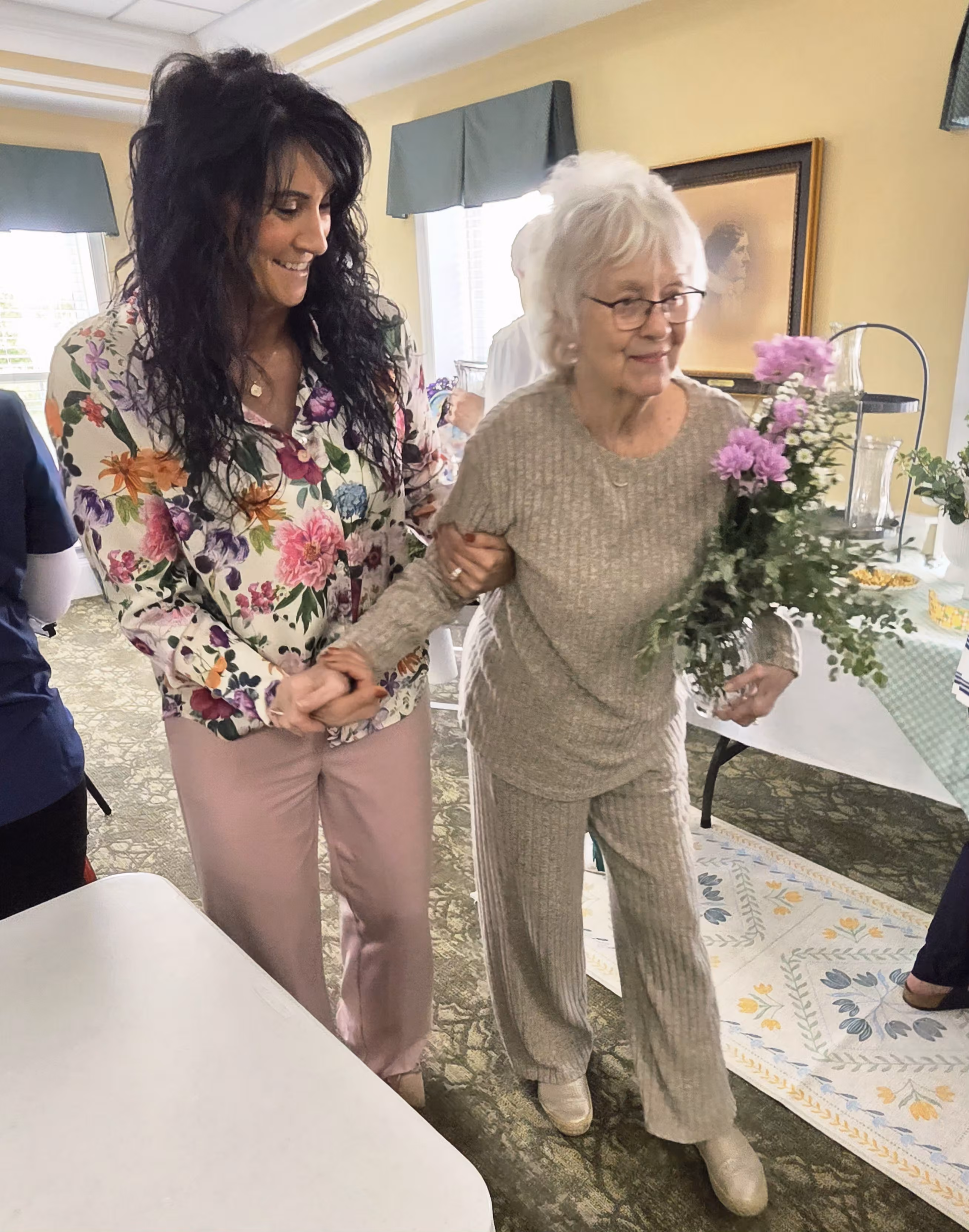 Image of a caregiver assisting a woman.