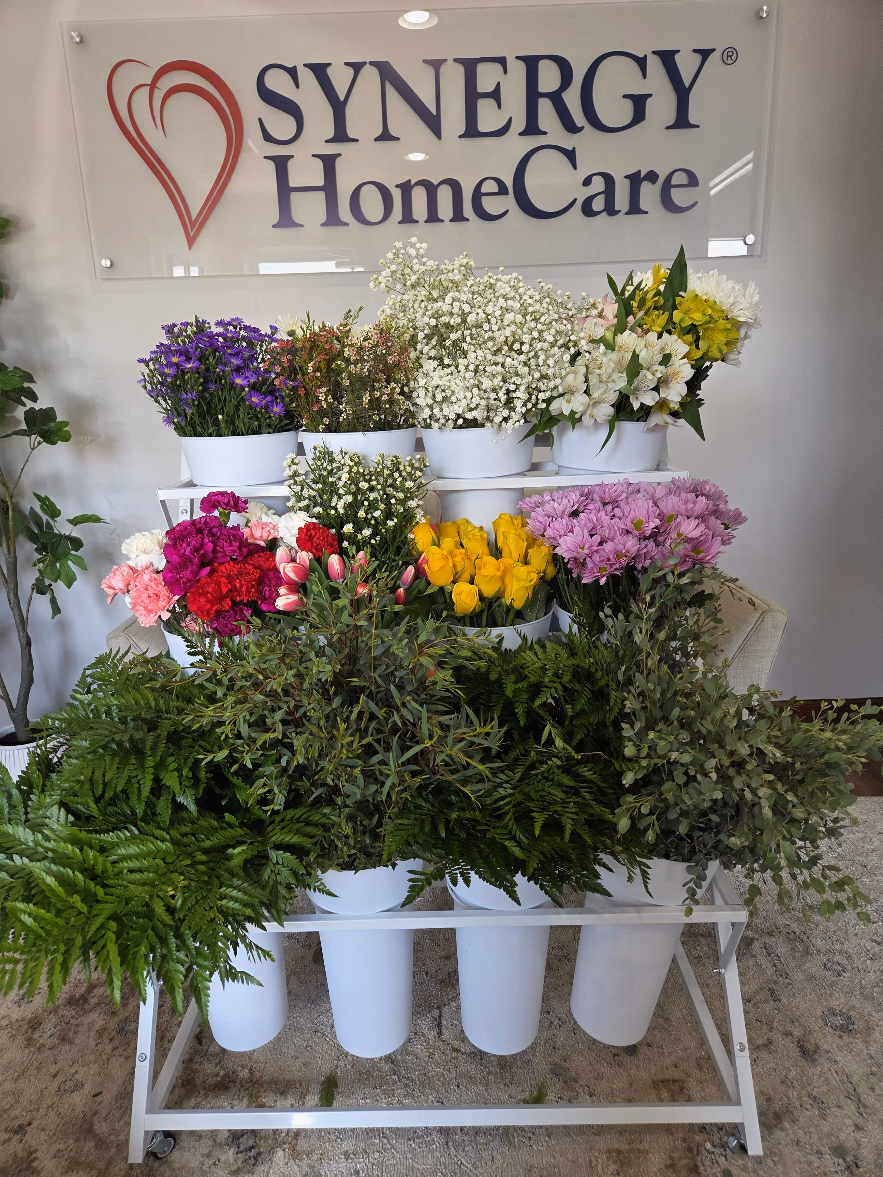 Image of a flower bar with the SYNERGY® HomeCare logo in the background.