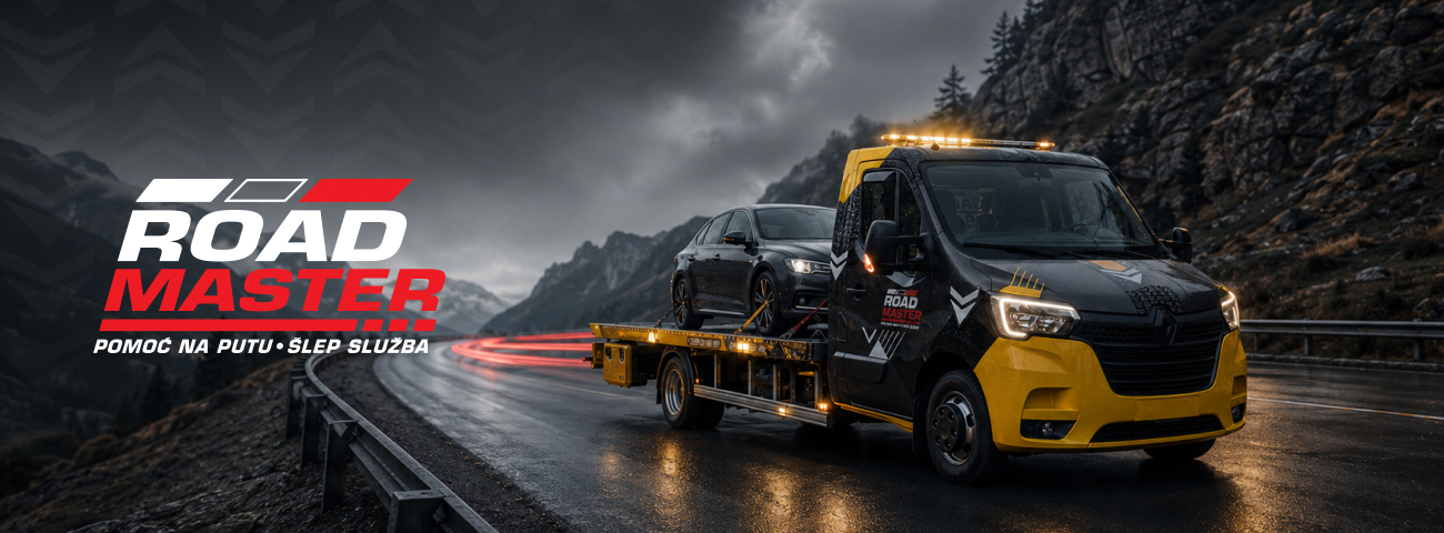 Black and yellow tow truck carrying car on wet mountain road with dark cloudy sky.