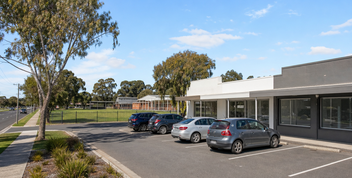 Modest shopping strip and nearby primary school in Whittington, showing the everyday amenity that supports the suburb's practical appeal
