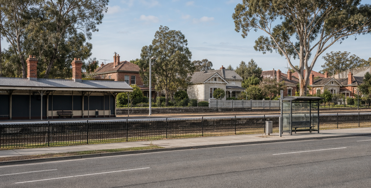 Modest train station and established homes on a Victorian street, illustrating the infrastructure access that supports investable suburbs.
