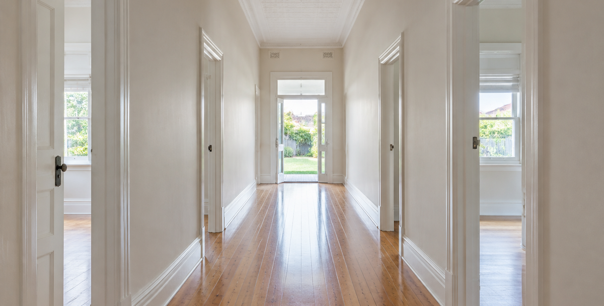 long hallway through an established Australian home toward the back garden, reflecting a property advisor starting with the investor's whole position.