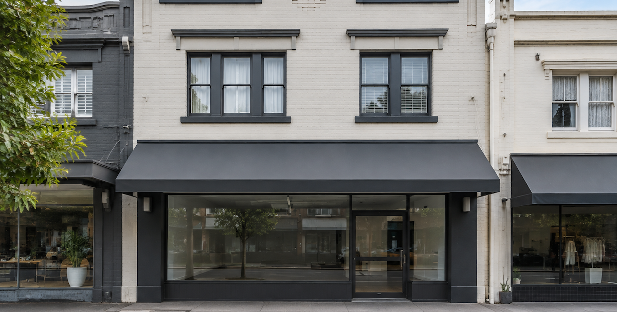 A shop-top building on an Australian shopping strip with a shopfront below and residence above , reflecting business owners and professionals who gain most from a property advisor.