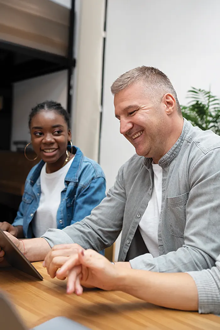 A carer and young person reading together