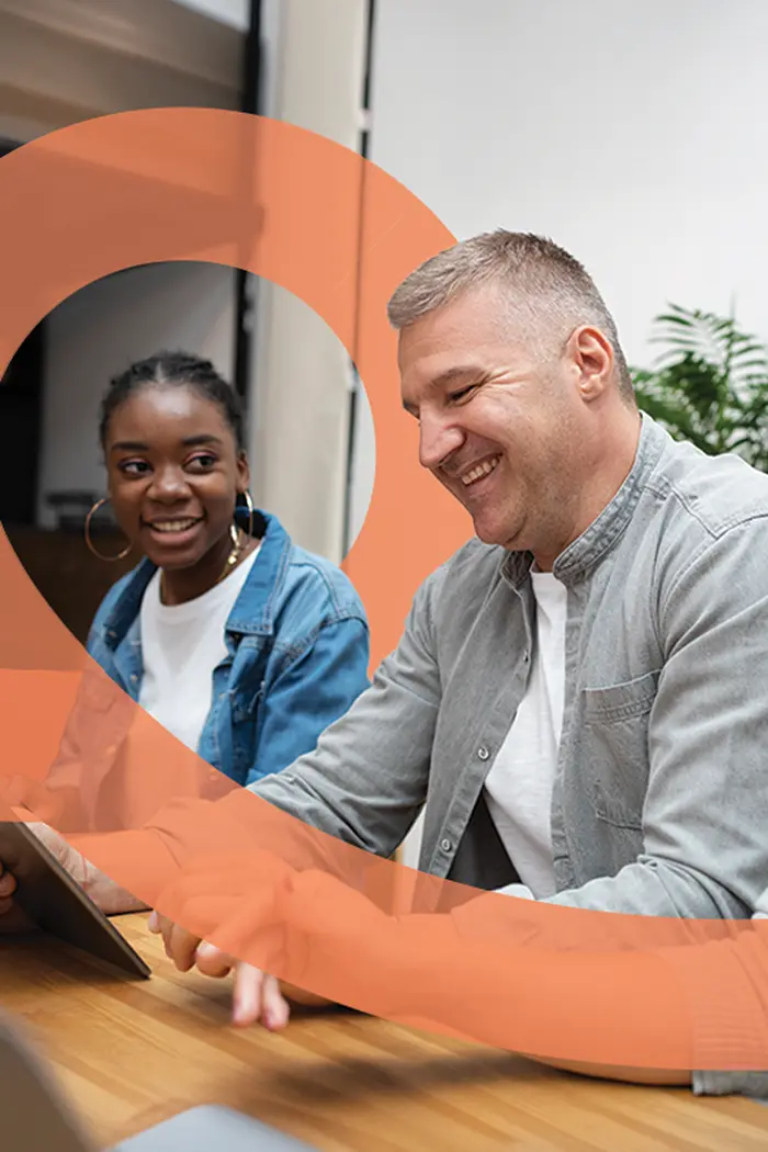 A carer and young person reading together