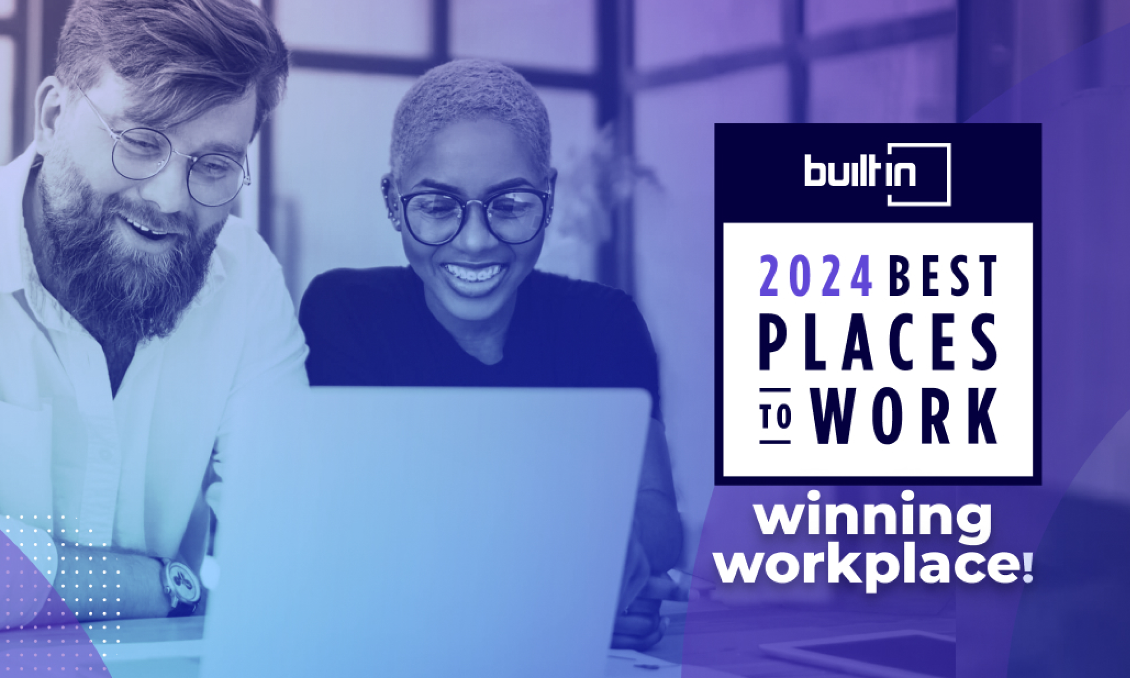 Two diverse coworkers smiling and looking at a laptop with a Built In 2024 Best Places to Work award badge.