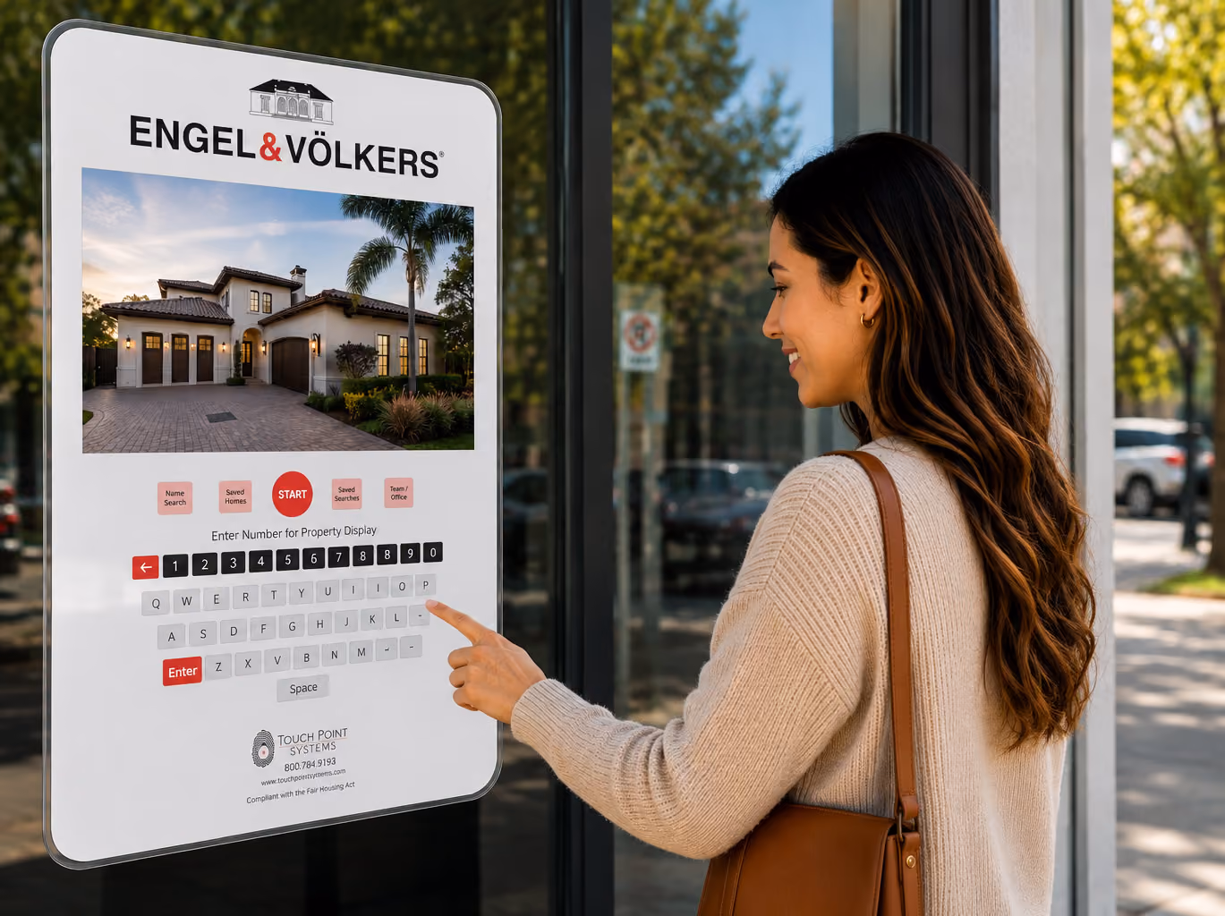Woman using a touchscreen real estate display for Engel & Völkers outside on a sunny day.