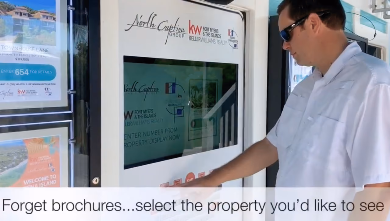 Man in sunglasses uses digital real estate kiosk from North Captiva Group Keller Williams Realty.