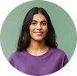 Smiling woman with long dark hair wearing a purple shirt against a green background.