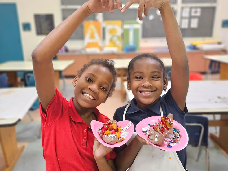 Smiling friends collaborating on a project in the Kidcreate studio